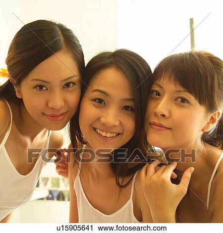 Stock Image - Close-Up, Asian Ethnicity, Cheerful, Casual Clothing, Brown Hair, Adults Only. Fotosearch