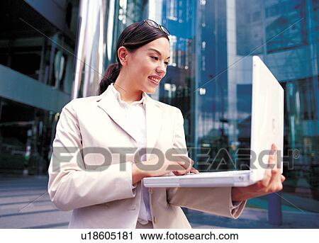 Stock Image - computer, laptop, buildings, standing, professional, outdoor. Fotosearch