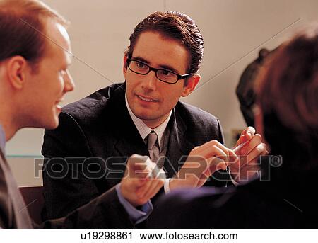 Stock Image - indoors, formal, holding, business, group, working. Fotosearch
