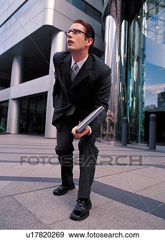 Stock Photo - one person, corporate, close-up, one man, white collar, business, buildings. Fotosearch