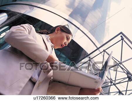 Stock Photograph - professional, facial expression, laptop, management, standing. Fotosearch