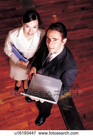 Stock Photo - professionals, one man, holding, employees, 25-35 years, equipment, executives. Fotosearch
