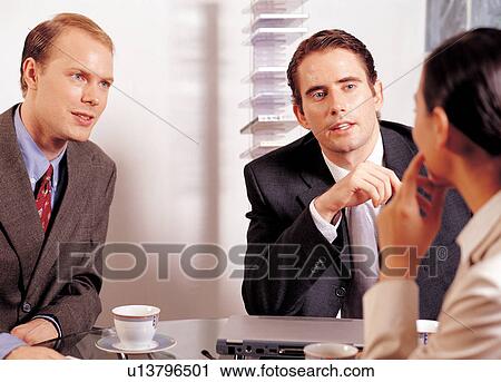 Stock Image - teacups, occupation, laptop, workers, young adults, gathering, training. Fotosearch