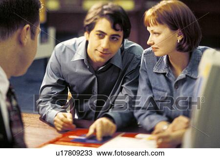 Stock Photo - Young Couple applying for a Loan. Fotosearch - Search Stock Images, Poster Photographs, Pictures, and Clip Art Photos