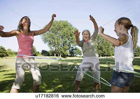 Stock Photograph - 3 generation women with hula hops. Fotosearch