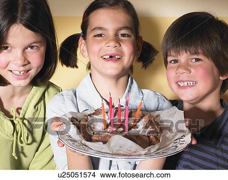 Picture - Children holding a birthday cake. Fotosearch