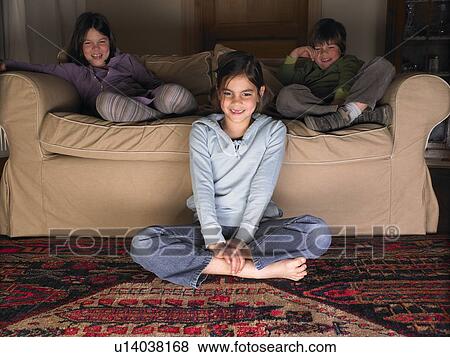 Children on sofa, watching tv View Large Photo Image Stock Photo - Children on sofa, watching tv. Fotosearch