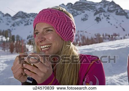 Stock Photo - Girl drinking, smiling. Fotosearch