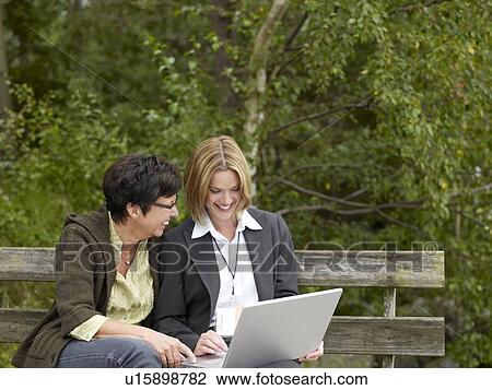 Mother and daughter looking at laptop computer View Large Photo Image Stock Image - Mother and daughter looking at laptop computer. Fotosearch