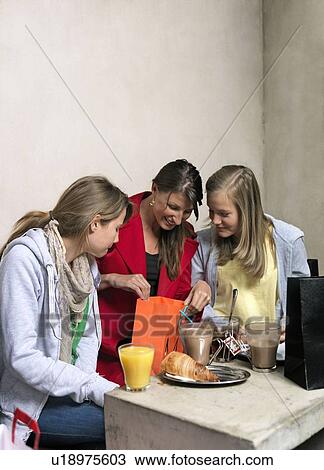 Stock Image - Mother with two girls shopping. Fotosearch