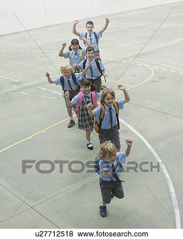 Stock Photo - School children running in courtyard. Fotosearch