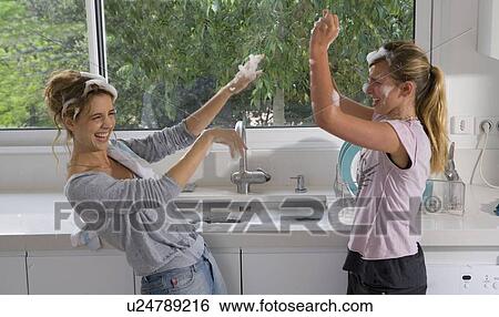 Sisters having bubble soap fight at sink View Large Photo Image Stock Photograph - Sisters having bubble soap fight at sink. Fotosearch