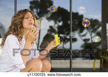 Woman blowing bubbles. View Large Photo Image Stock Photography - Woman blowing bubbles.. Fotosearch