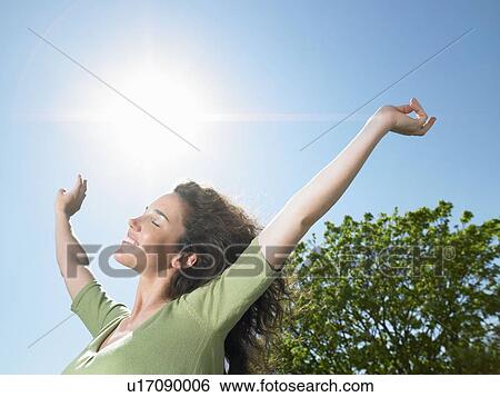 Woman enjoying the sun View Large Photo Image Stock Photograph - Woman enjoying the sun. Fotosearch