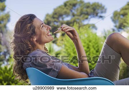 Woman on a wooden terrace by a pool View Large Photo Image Stock Photo - Woman on a wooden terrace by a pool. Fotosearch