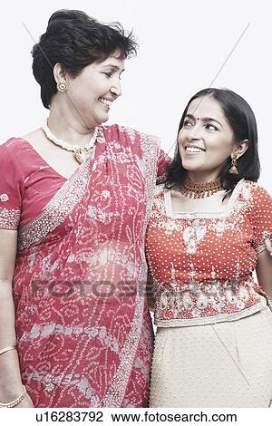 Close-up of a mother and her daughter looking at each other View Large Photo Image Stock Image - Close-up of a mother and her daughter looking at each other. Fotosearch