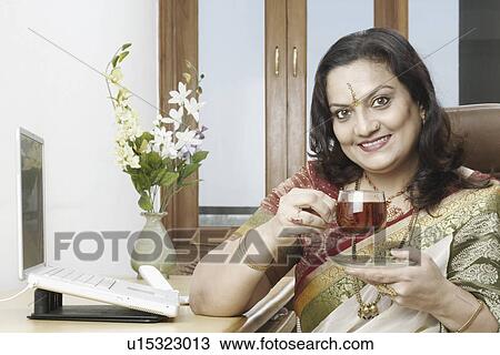 Portrait of a mature woman holding a cup of black tea View Large Photo Image Stock Image - Portrait of a mature woman holding a cup of black tea. Fotosearch
