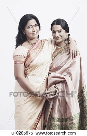 Stock Photography - Portrait of a mature woman standing with a mid adult woman. Fotosearch