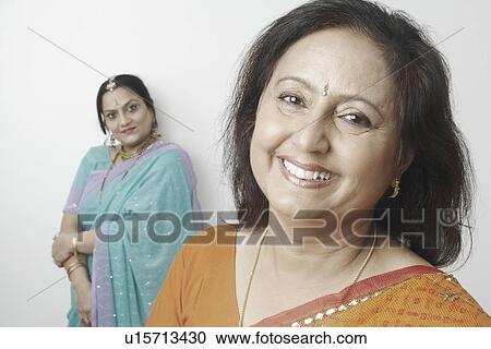 Stock Image - Portrait of a mature woman with another mature woman standing behind her. Fotosearch