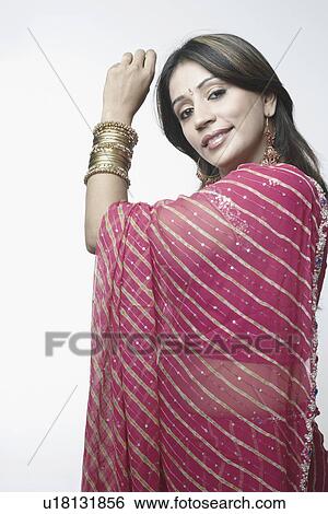 Stock Photograph - Portrait of a mid adult woman showing her bangles. Fotosearch
