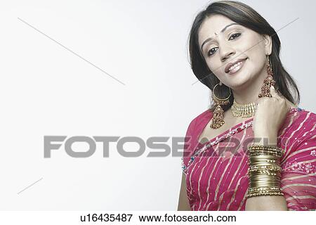 Portrait of a mid adult woman touching her earrings View Large Photo Image Stock Photo - Portrait of a mid adult woman touching her earrings. Fotosearch