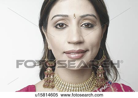 Portrait of a mid adult woman wearing a necklace and earrings View Large Photo Image Stock Photography - Portrait of a mid adult woman wearing a necklace and earrings. Fotosearch
