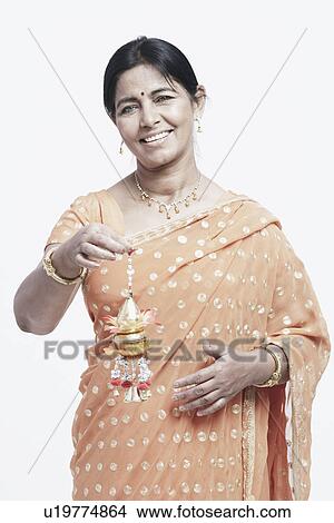 Picture - Portrait of a young woman holding a tassel. Fotosearch