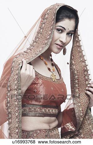 Stock Photo - Portrait of a young woman in traditional clothing smiling. Fotosearch