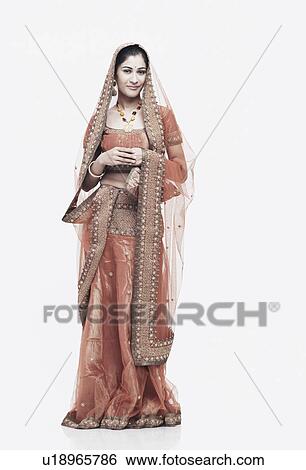 Stock Photograph - Portrait of a young woman in traditional clothing smiling. Fotosearch