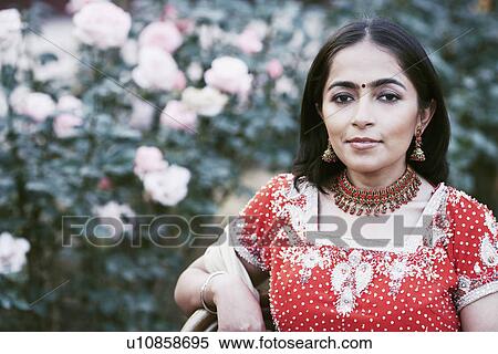 Stock Photography - Portrait of a young woman smiling in the garden. Fotosearch