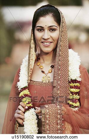 Portrait of a young woman wearing a garland View Large Photo Image Stock Image - Portrait of a young woman wearing a garland. Fotosearch