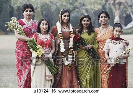Portrait of two mothers smiling with their daughters View Large Photo Image Stock Photograph - Portrait of two mothers smiling with their daughters. Fotosearch