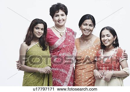 Stock Image - Portrait of two mothers standing with their daughters. Fotosearch
