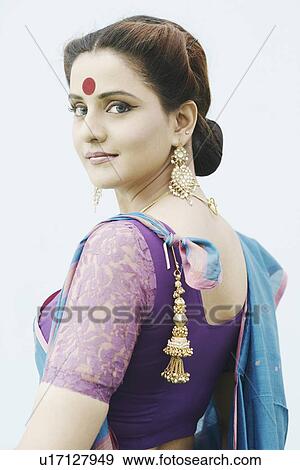 Stock Photo - Side profile of a young woman wearing a sari. Fotosearch