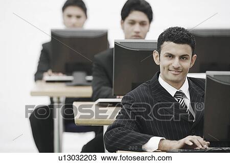 Stock Image - Businessman working on a computer. Fotosearch