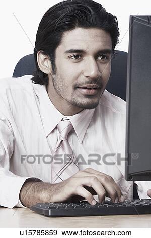 Stock Photo - Close-up of a businessman using a computer. Fotosearch
