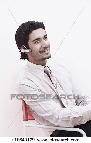 Stock Photo - Close-up of a businessman wearing a hands free device. Fotosearch