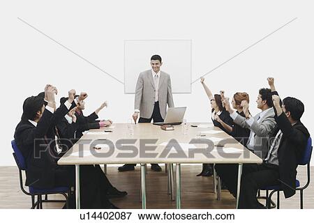 Group of business executives raising their hands at a presentation View Large Photo Image Stock Photo - Group of business executives raising their hands at a presentation. Fotosearch
