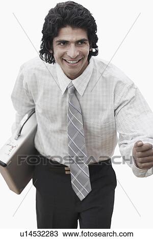 Stock Image - High angle view of a businessman holding a briefcase. Fotosearch