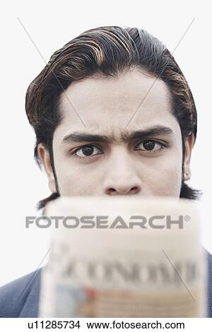 Picture - Portrait of a businessman holding a newspaper. Fotosearch