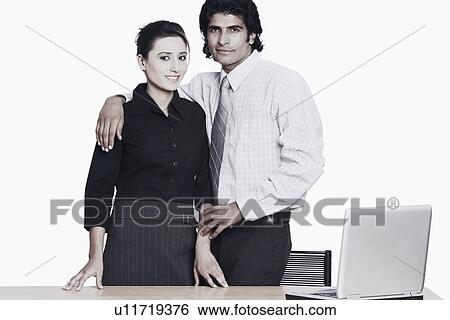 Stock Photograph - Portrait of a businessman standing with a businesswoman. Fotosearch