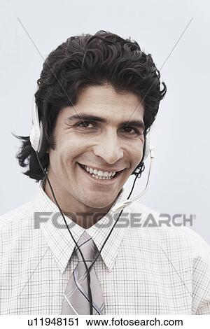 Portrait of a businessman wearing a headset View Large Photo Image Stock Image - Portrait of a businessman wearing a headset. Fotosearch