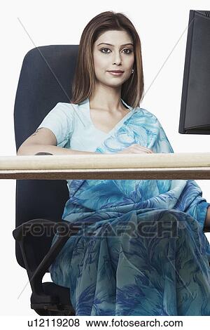 Stock Photo - Portrait of a businesswoman sitting in front of a computer. Fotosearch