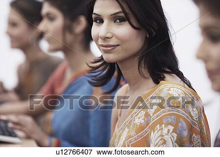 Stock Photo - Portrait of a businesswoman sitting in front of a computer. Fotosearch