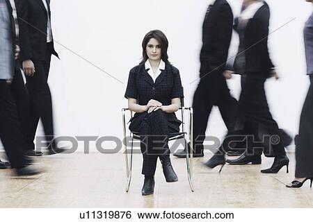 Stock Photograph - Portrait of a businesswoman sitting on a chair. Fotosearch