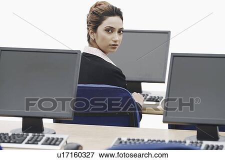 Stock Photo - Portrait of a businesswoman working on a computer. Fotosearch