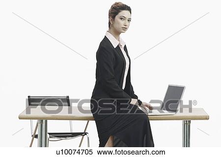 Stock Photography - Portrait of a businesswoman working on a laptop. Fotosearch