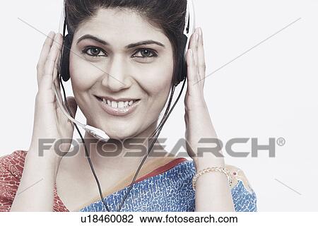 Portrait of a young woman wearing a headset View Large Photo Image Stock Image - Portrait of a young woman wearing a headset. Fotosearch