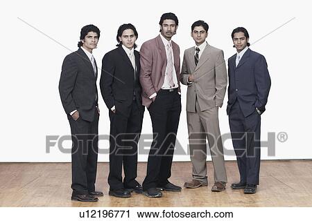 Portrait of five businessmen standing with their hands in their pockets View Large Photo Image Stock Image - Portrait of five businessmen standing with their hands in their pockets. Fotosearch