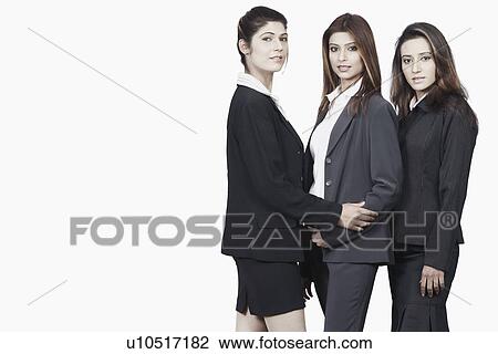 Stock Image - Portrait of three businesswomen smiling. Fotosearch